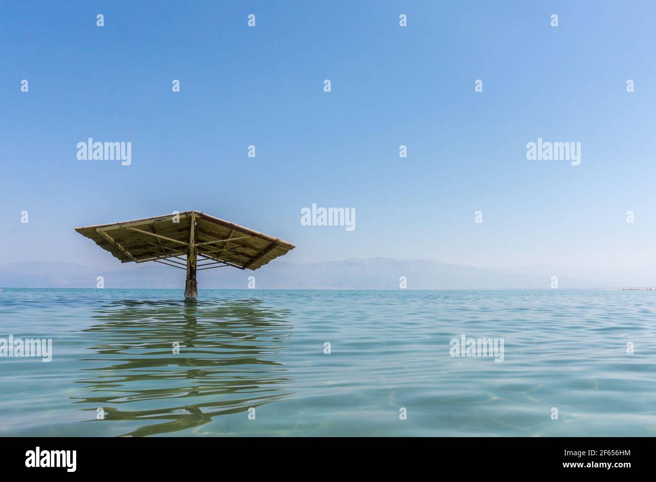 Sunshade to protect from the sun in the water of the Dead sea on a beautiful Sunny day. Stock Photo