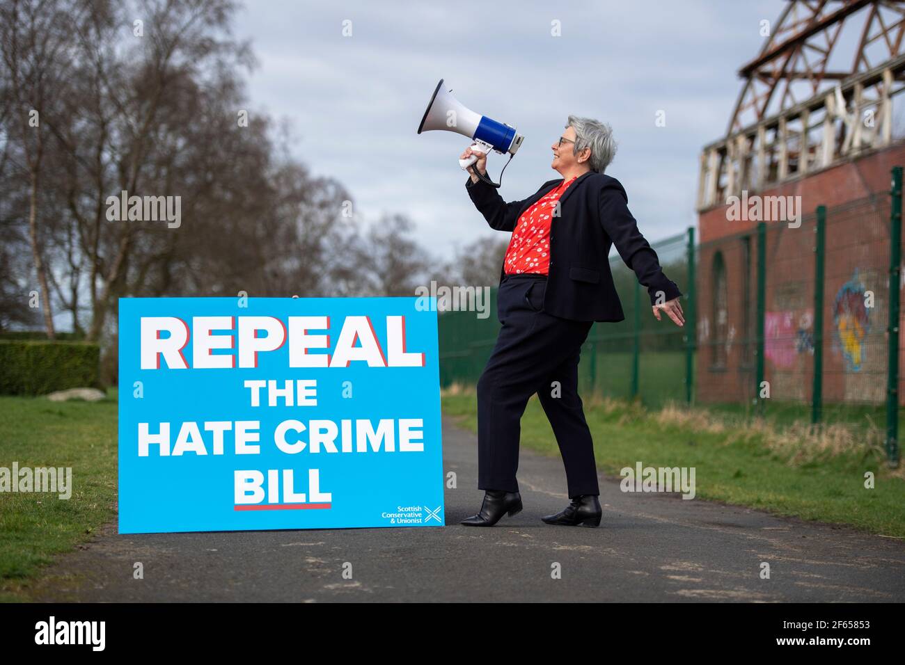 Glasgow, Scotland, UK. 30 March 2021. PICTURED: Annie Wells MSP shorts from the hill tops at Glasgow’s Springburn Winter Gardens with a loudspeaker on the party’s bid to repeal the Hate Crime Bill on the Holyrood Election campaign trail.  Credit: Colin Fisher/Alamy Live News Stock Photo