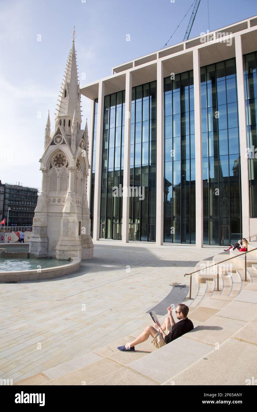 Birmingham, UK. 30th Mar, 2021. A man relaxes in the sun in the newly-developed Chamberlain Square in Birmingham city centre. Credit: Peter Lopeman/Alamy Live News Stock Photo