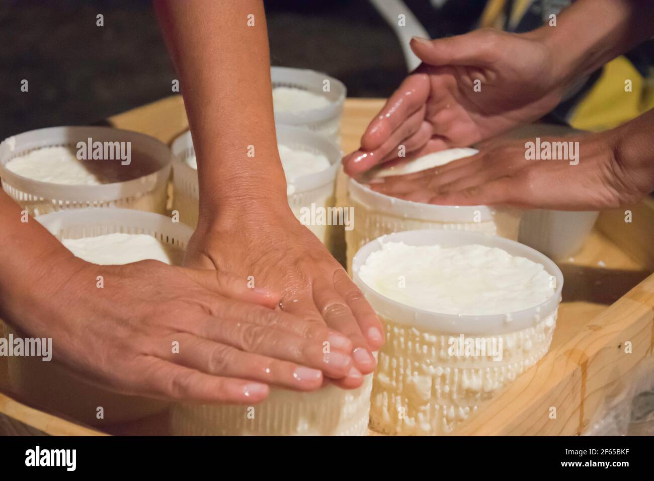 hands, hand making fresh cheese in traditional process in apulia the land of trulli houses in southern italy; artisanality and foodporn Stock Photo