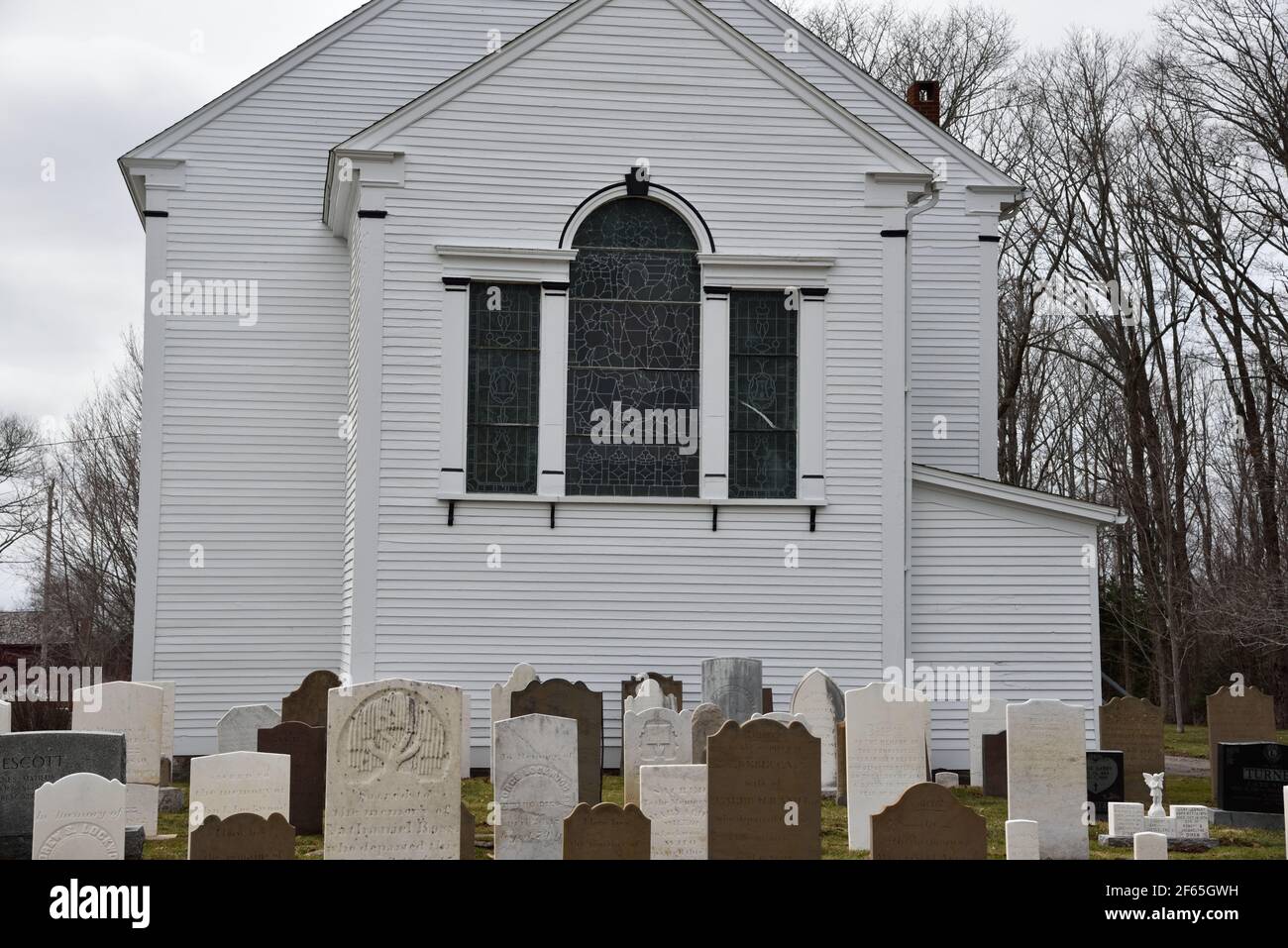 Lovely old white clapboard St. John's Anglican Church established in 1760 Surrounded by old gravestones in Port Williams, Nova Scotia Canada Stock Photo