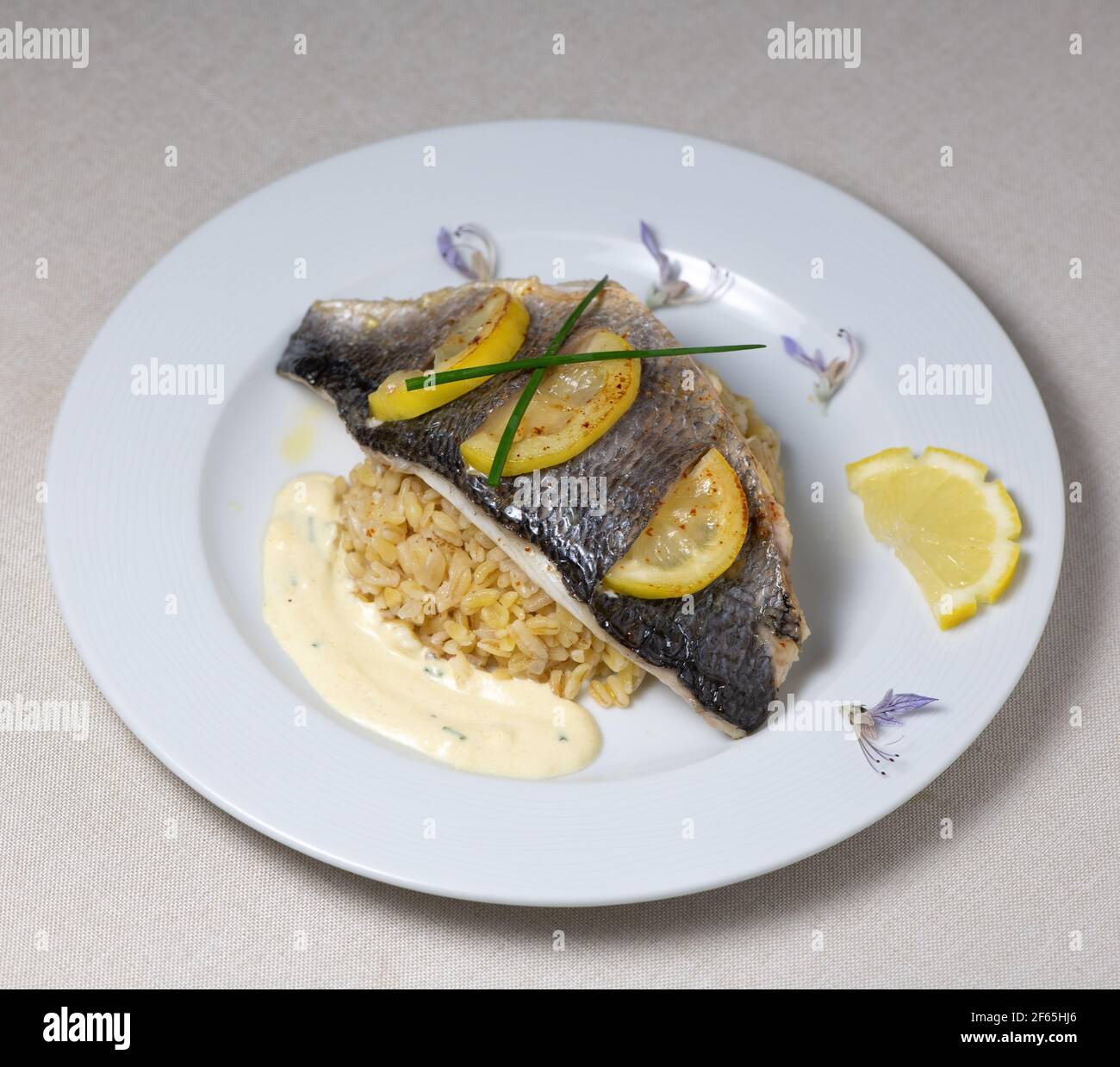 Lemon spiked sea bream fillet, cooked wheat risotto  Stock Photo