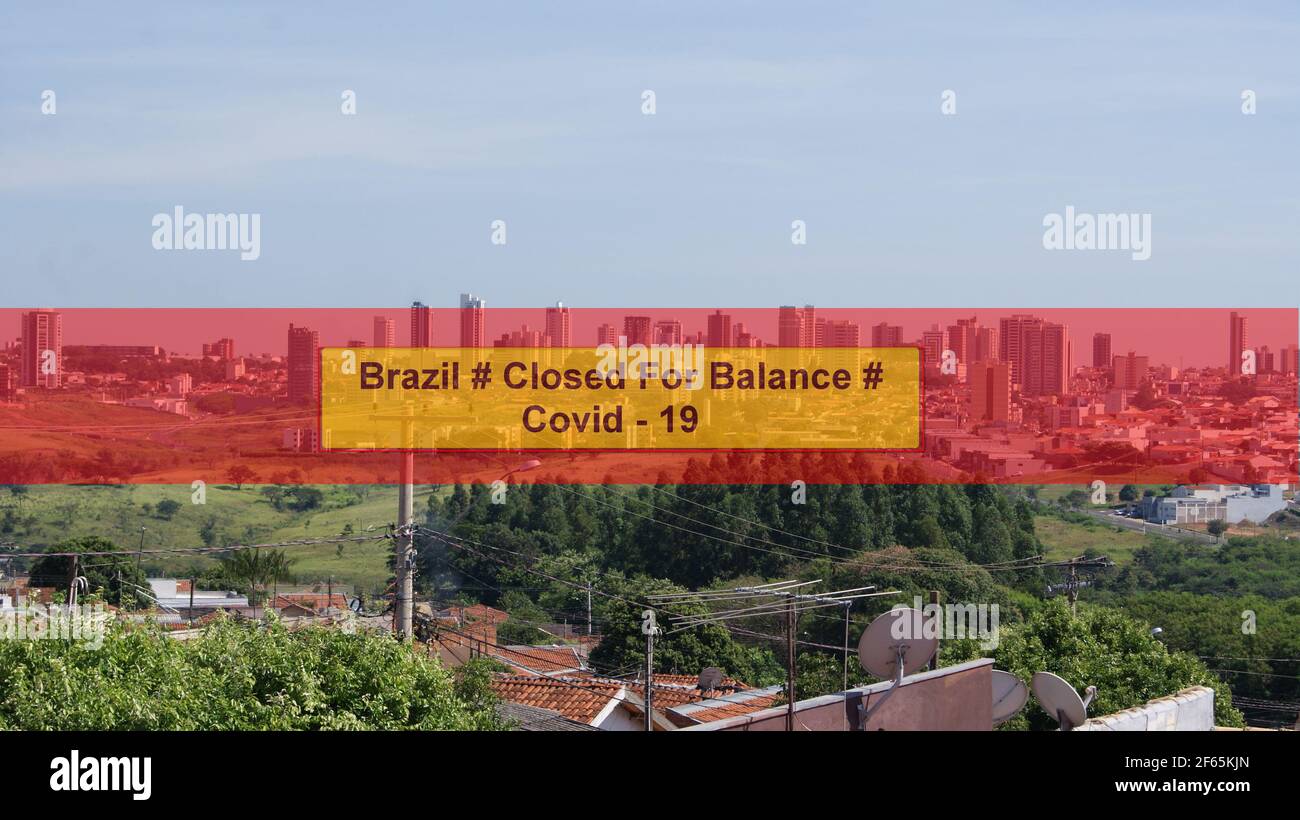 Photo with the inscription Brazil Closed for Balance in red, yellow and orange in the background in a panoramic view of the city center in Brazil, Sou Stock Photo