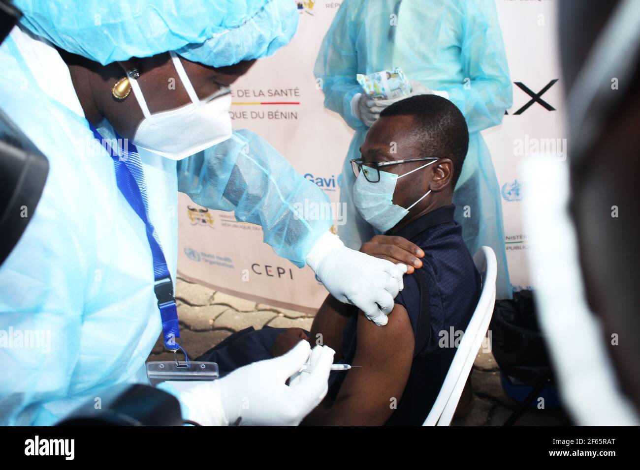 (210330) -- COTONOU, March 30, 2021 (Xinhua) -- Benin's Minister of Health Benjamin Hounkpatin receives a shot of COVID-19 vaccine at the Congress Palace of Cotonou, Benin, March 29, 2021. Benin launched on Monday the first phase of vaccination against COVID-19 that targets groups including health workers and people aged 60 and above. (Photo by Seraphin Zounyekpe/Xinhua) Stock Photo