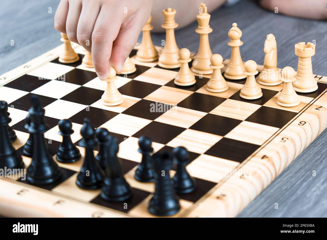 Hand of a woman starting chess game. Concept of playing chess at home,  hobbies at home Stock Photo - Alamy