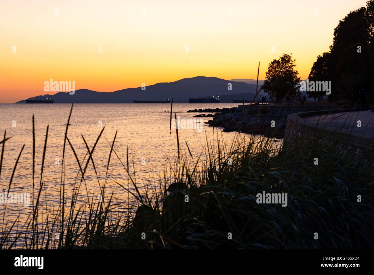 Sunset in summer at English Bay beach in Vancouver, British Columbia, Canada Stock Photo