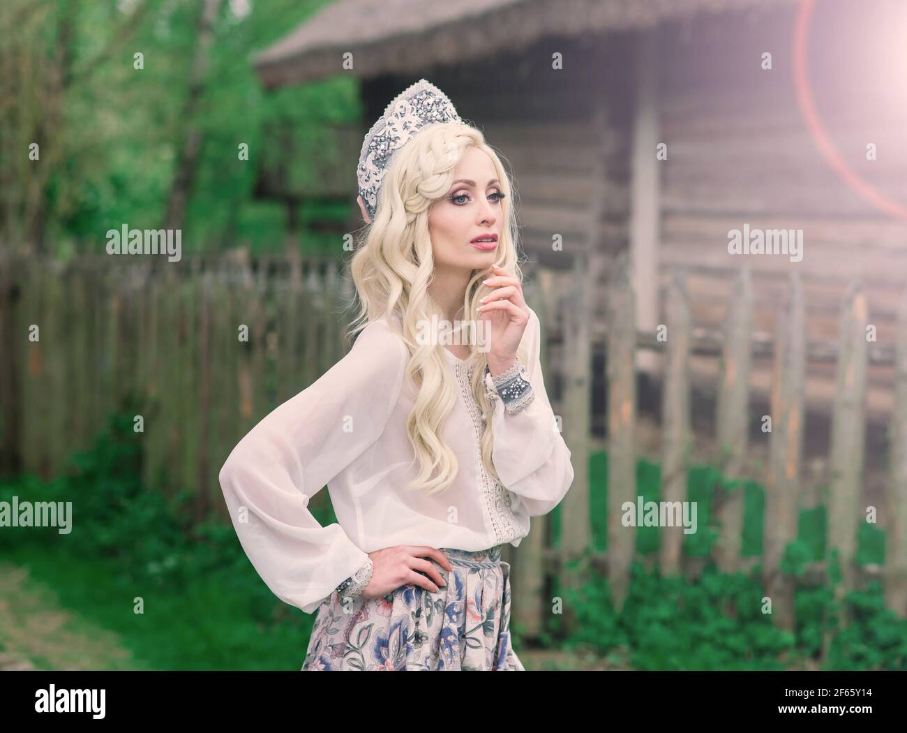 https://c8.alamy.com/comp/2F65Y14/young-female-of-slavic-appearance-with-crown-kokoshnik-on-the-midsummer-village-homestead-2F65Y14.jpg
