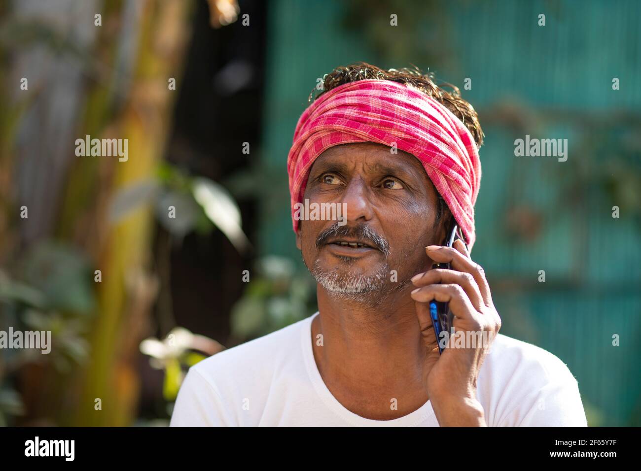 Indian farmer talking on mobile phone Stock Photo