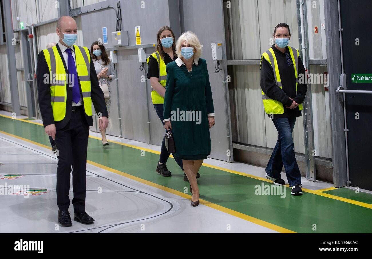 The Duchess of Cornwall being shown around the warehouse by Warehouse Manager Graeme Rott (left) and Warehouse staff Zoe Hough and Jenny Milton during a visit to the Kamsons Pharmacy head office and warehouse in Uckfield, East Sussex, to thank frontline workers. Picture date: Tuesday March 30, 2021. Stock Photo