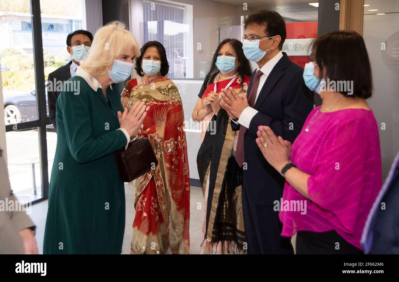 The Duchess of Cornwall meets members of the Chotai family during a visit to the Kamsons Pharmacy head office and warehouse in Uckfield, East Sussex, to thank frontline workers. Picture date: Tuesday March 30, 2021. Stock Photo