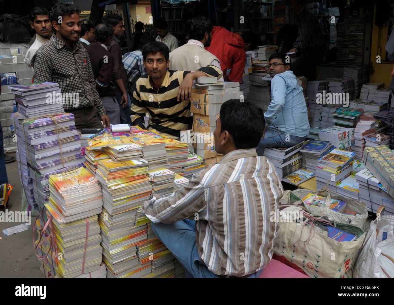 Everyday scene on College Street, Kolkatta, India.  The half-mile street of bookshops and bookstalls spills over onto the pavement where all kinds of Stock Photo
