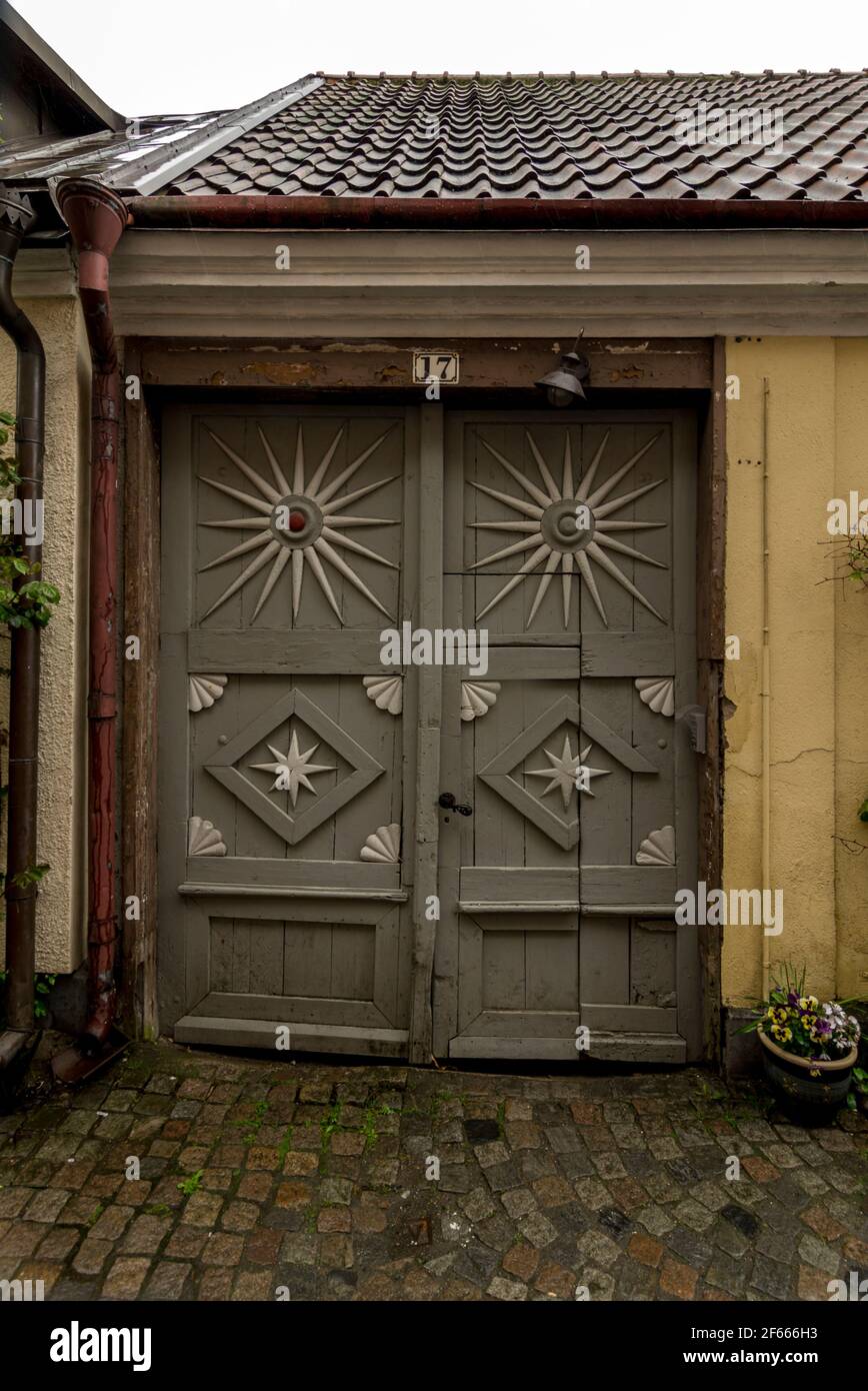 Carved wooden doors (to a shed or garage?) nr Stortoget, Ystad, Sweden. Stock Photo