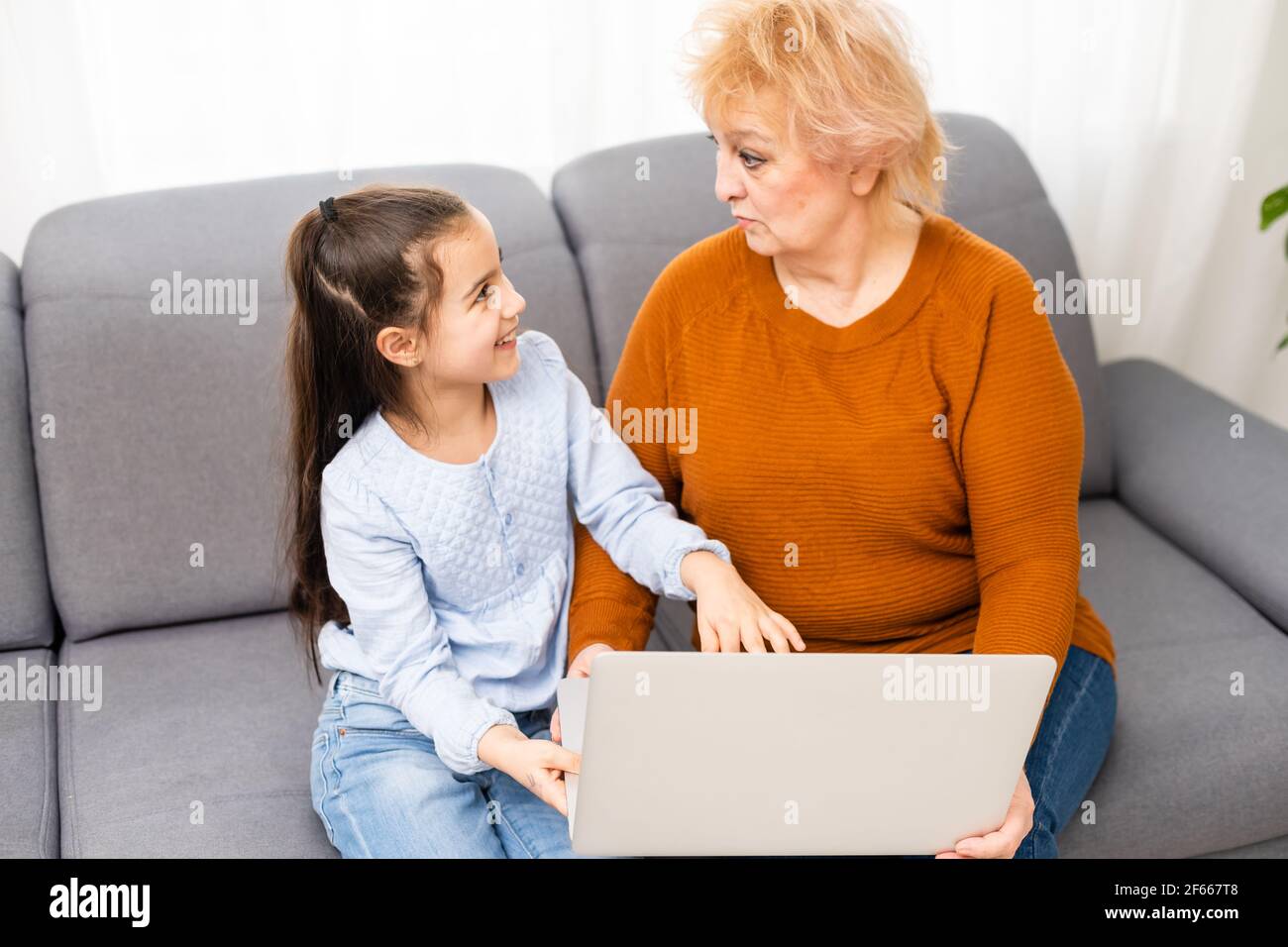 Grandmother and granddaughter with laptop Stock Photo - Alamy