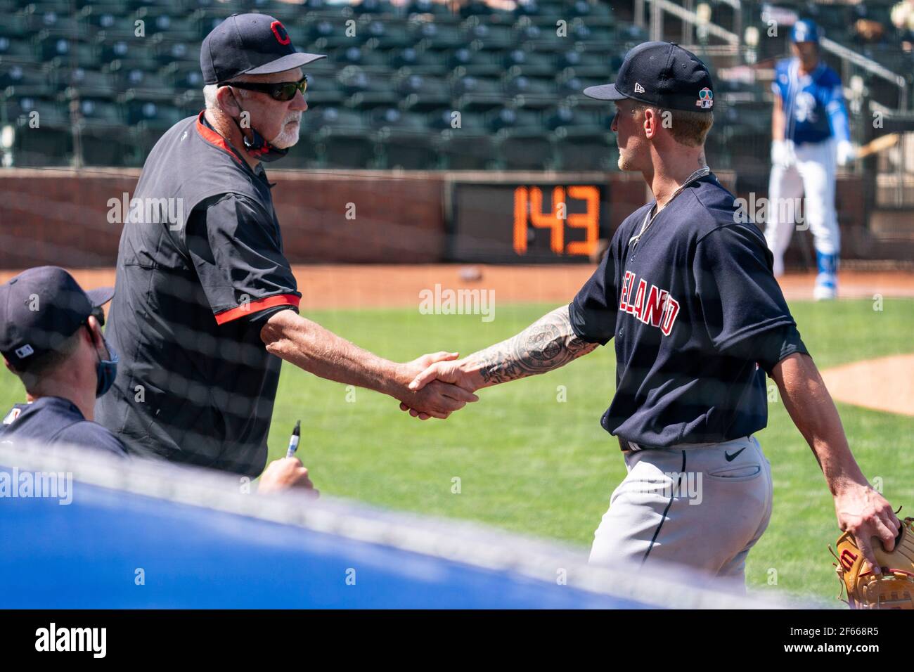Cleveland Indians pitching coach Carl Willis (51) congratulates starting  pitcher Zach Plesac (34) after his performance during a spring training  game Stock Photo - Alamy