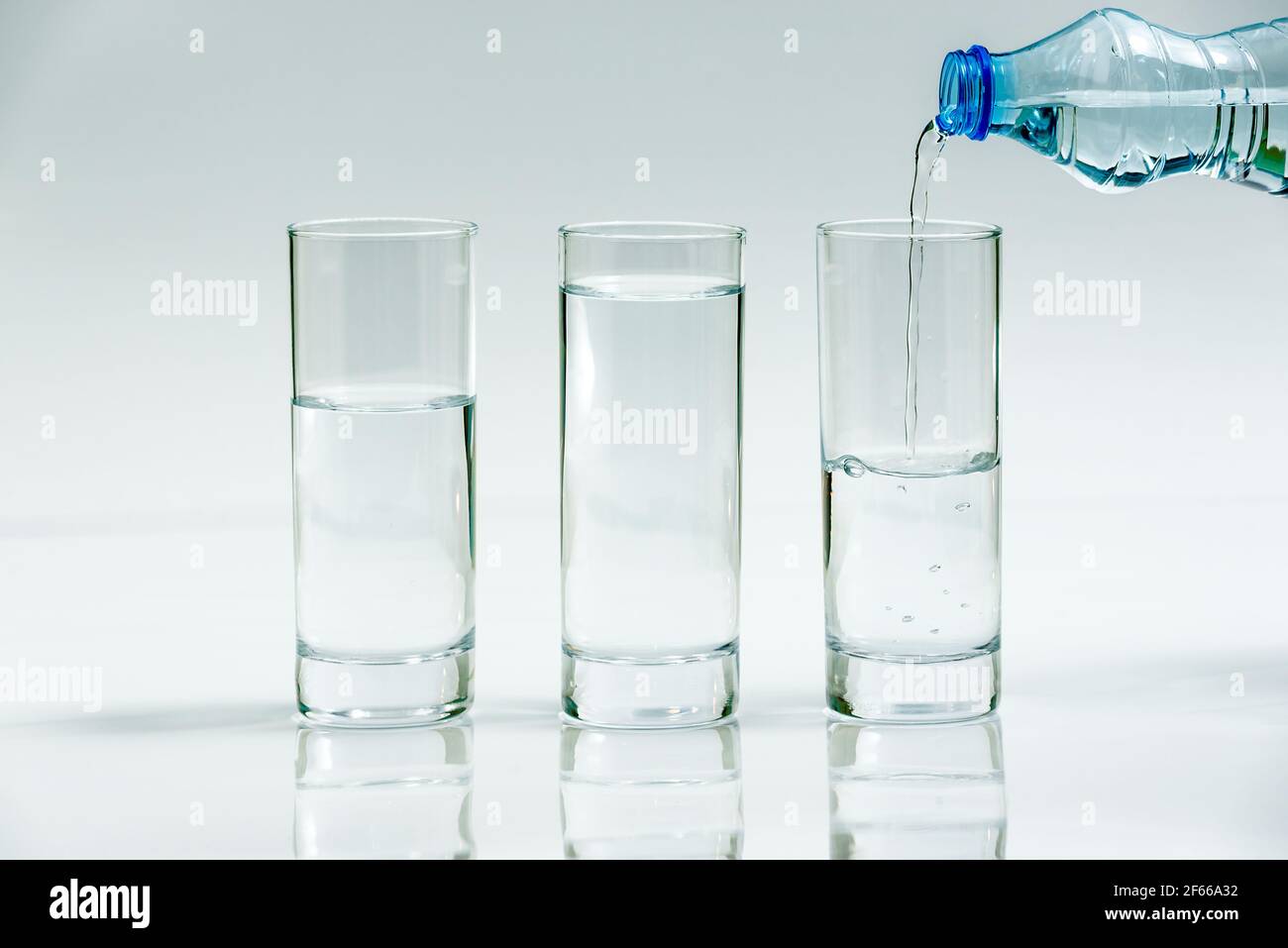 https://c8.alamy.com/comp/2F66A32/water-bottle-pour-water-water-into-three-glasses-different-level-on-white-background-three-glasses-of-water-2F66A32.jpg