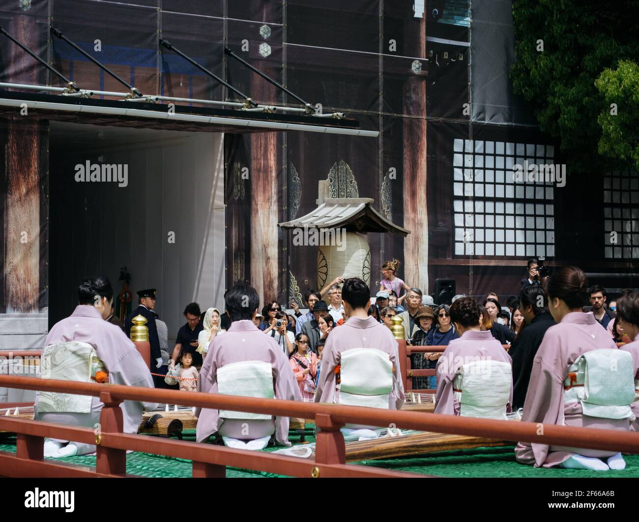 Tokyo, Japan Female musicians wearing traditional clothes and playing Koto, a Japanese plucked