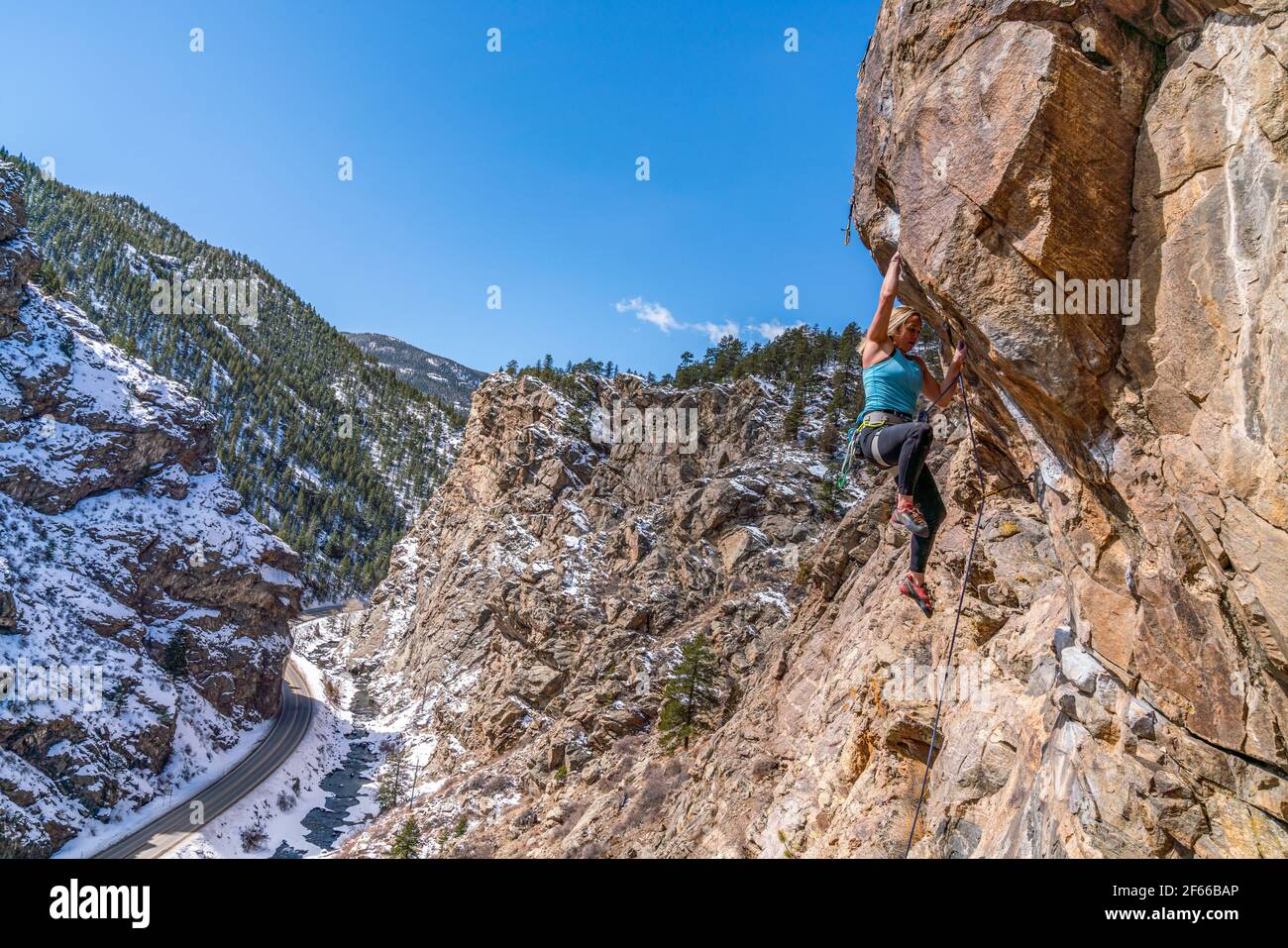 3/27/21 Golden, Colorado - A woman works out the moves on a steep rock climb in Clear Creek Canyon. Stock Photo