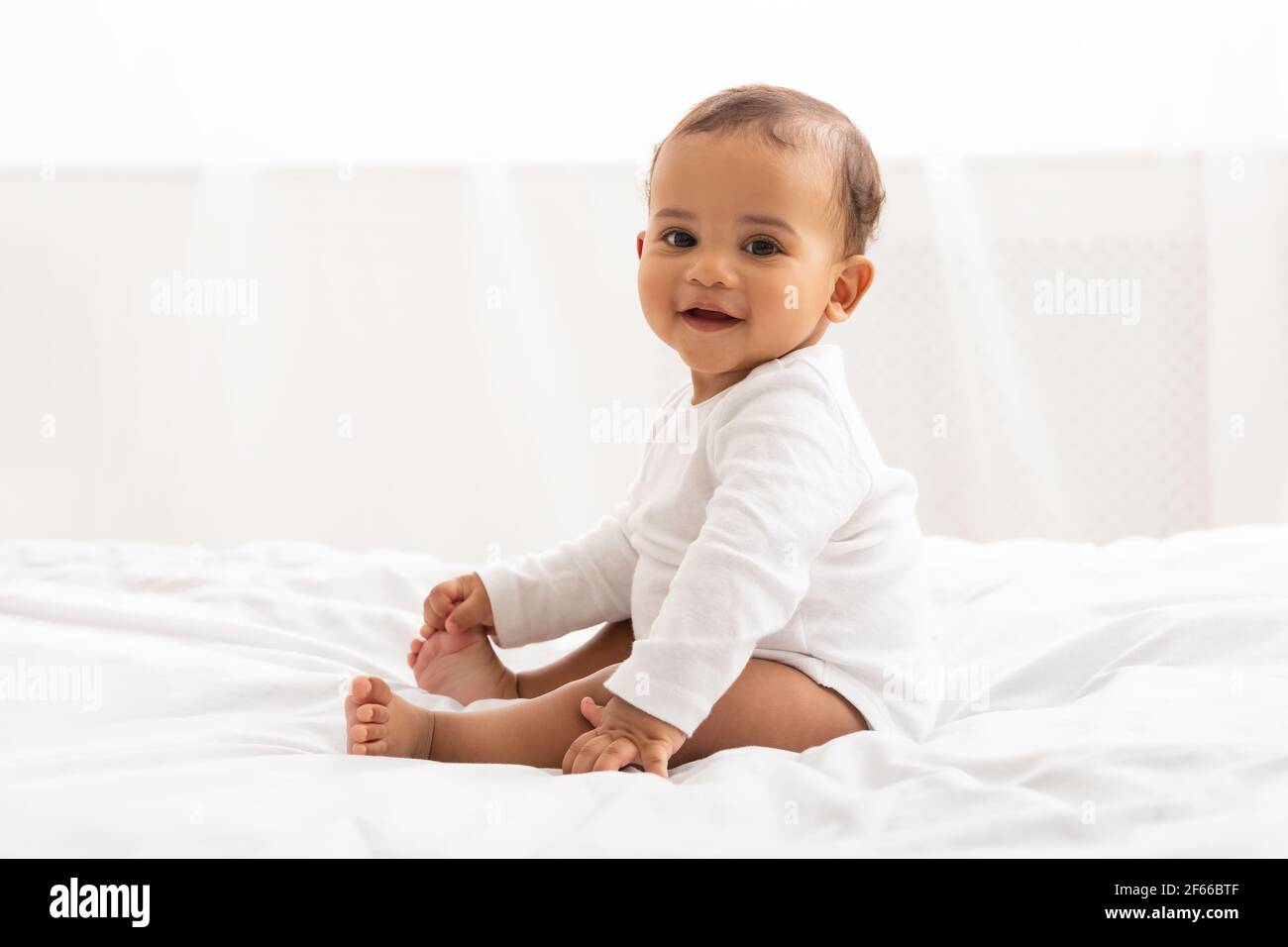 Beautiful African Baby Boy Sitting In Bed Posing In Bedroom Stock Photo ...