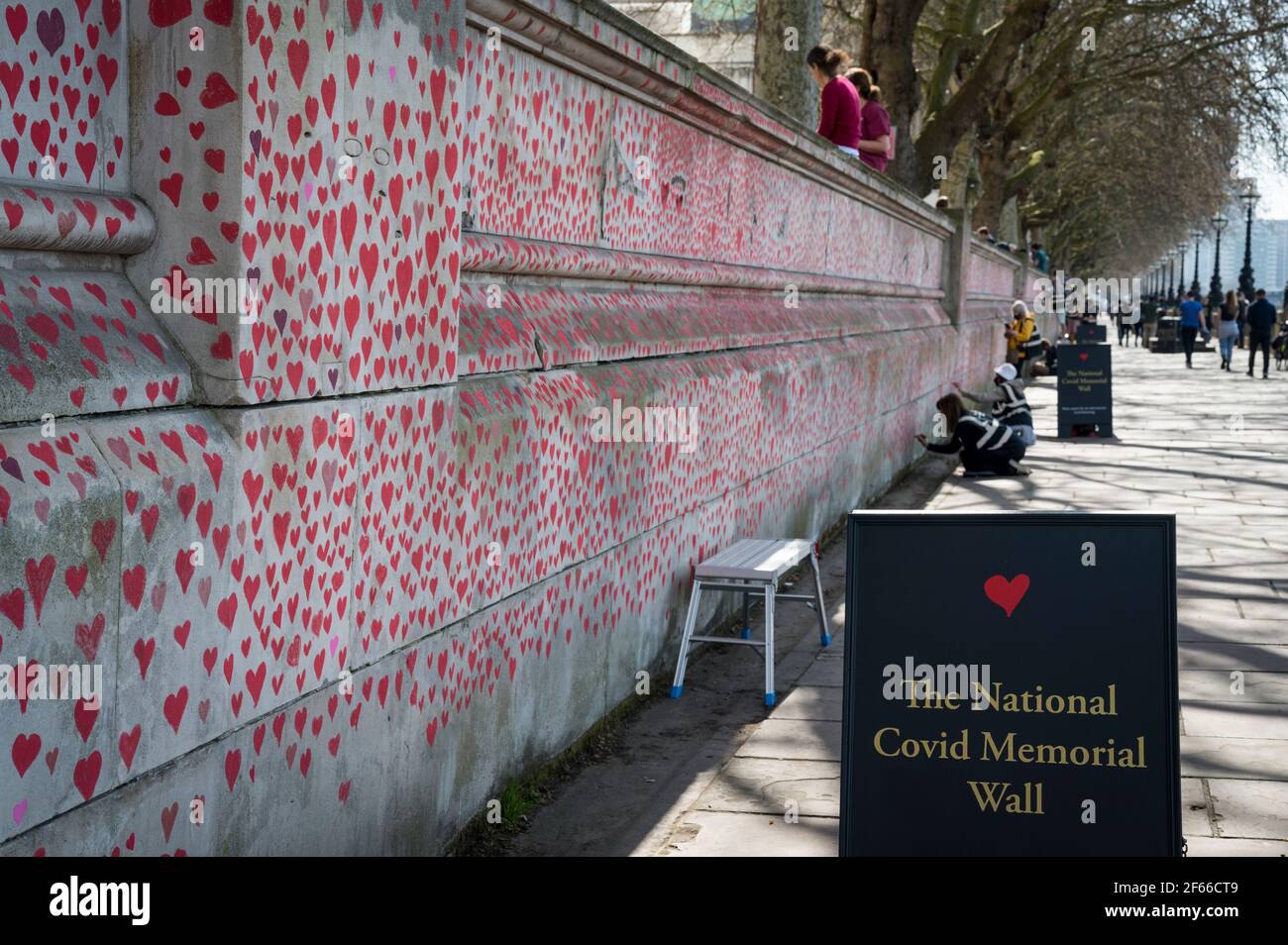 London, UK. 30th Mar, 2021. A sign for a wall of hearts at The National Covid Memorial Wall in Lambeth by the River Thames, with each heart representing someone who died during the UK's ongoing coronavirus pandemic. Called The National Covid Memorial Wall, it has been created by the Covid-19 Bereaved Families for Justice and will extend for half a mile by the time it is complete. Credit: Stephen Chung/Alamy Live News Stock Photo