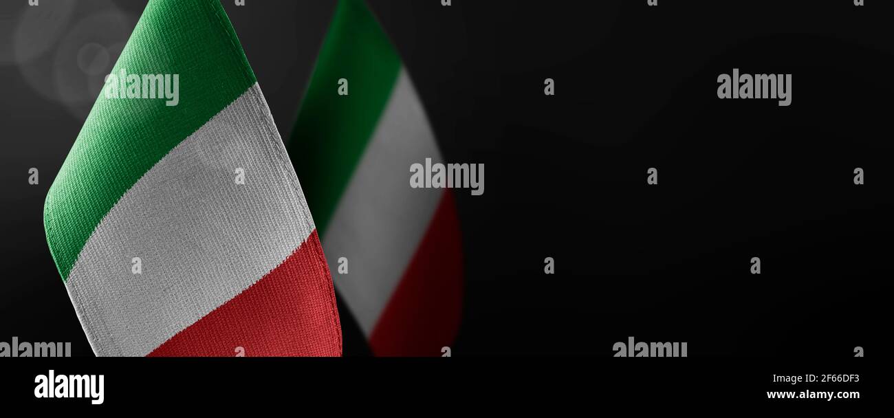 Small national flags of the Italy on a dark background Stock Photo