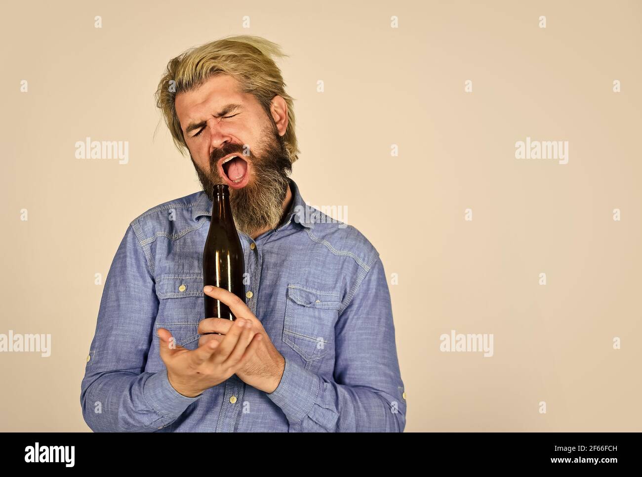 Alcoholism problem. Man with tousled hair looks unhealthy. Hangover