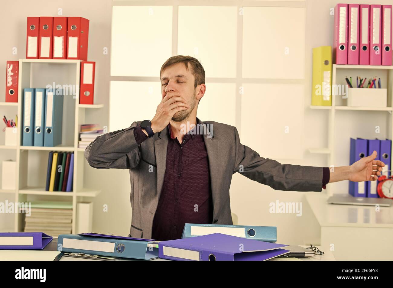 Man lawyer stretching muscles sit table exhaust with too much work ...