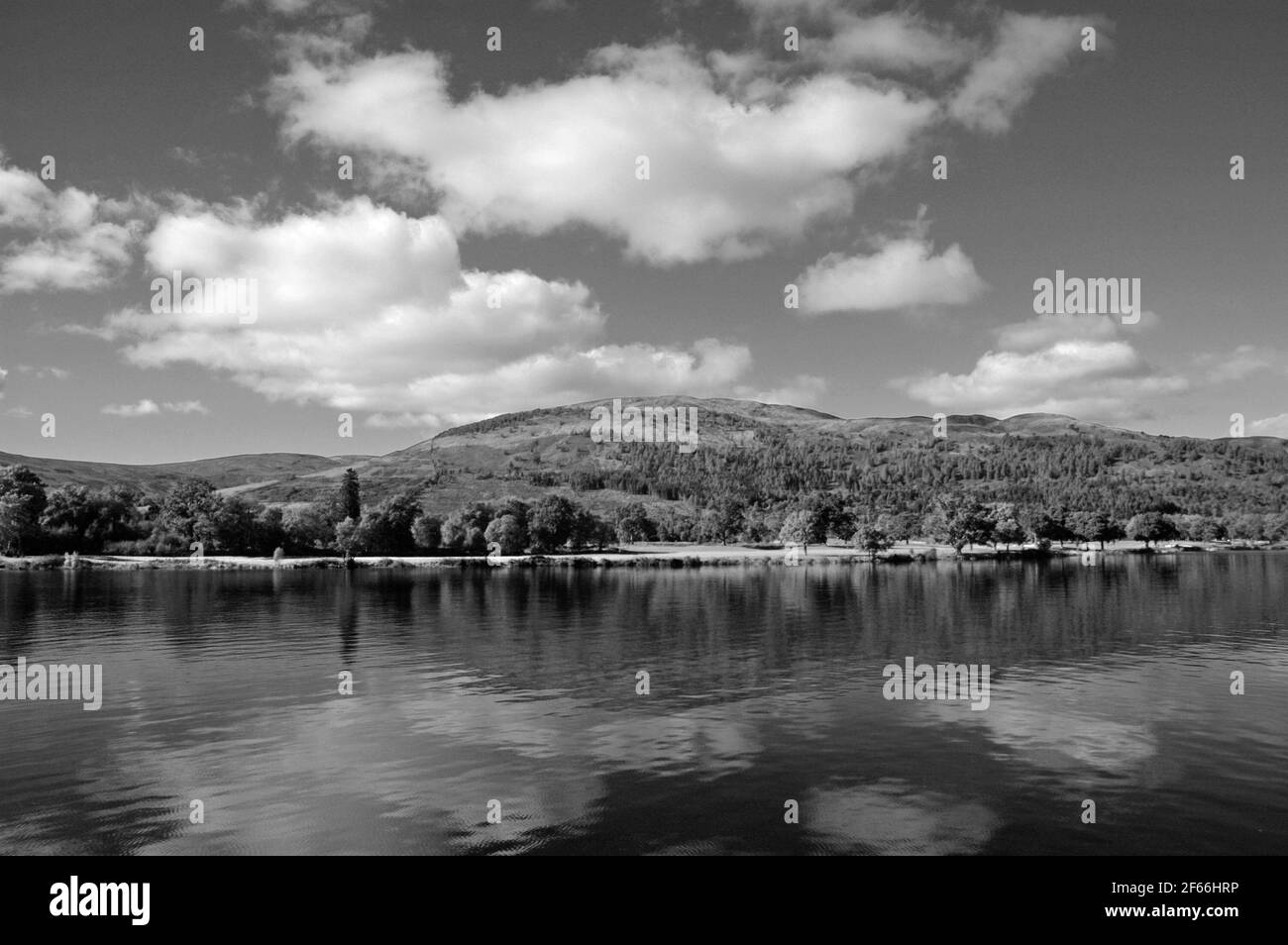 Wide angle, panoramic view of the pristine waters of Loch Lomond with the mountains of the Scottish Highlands in the background. Stock Photo