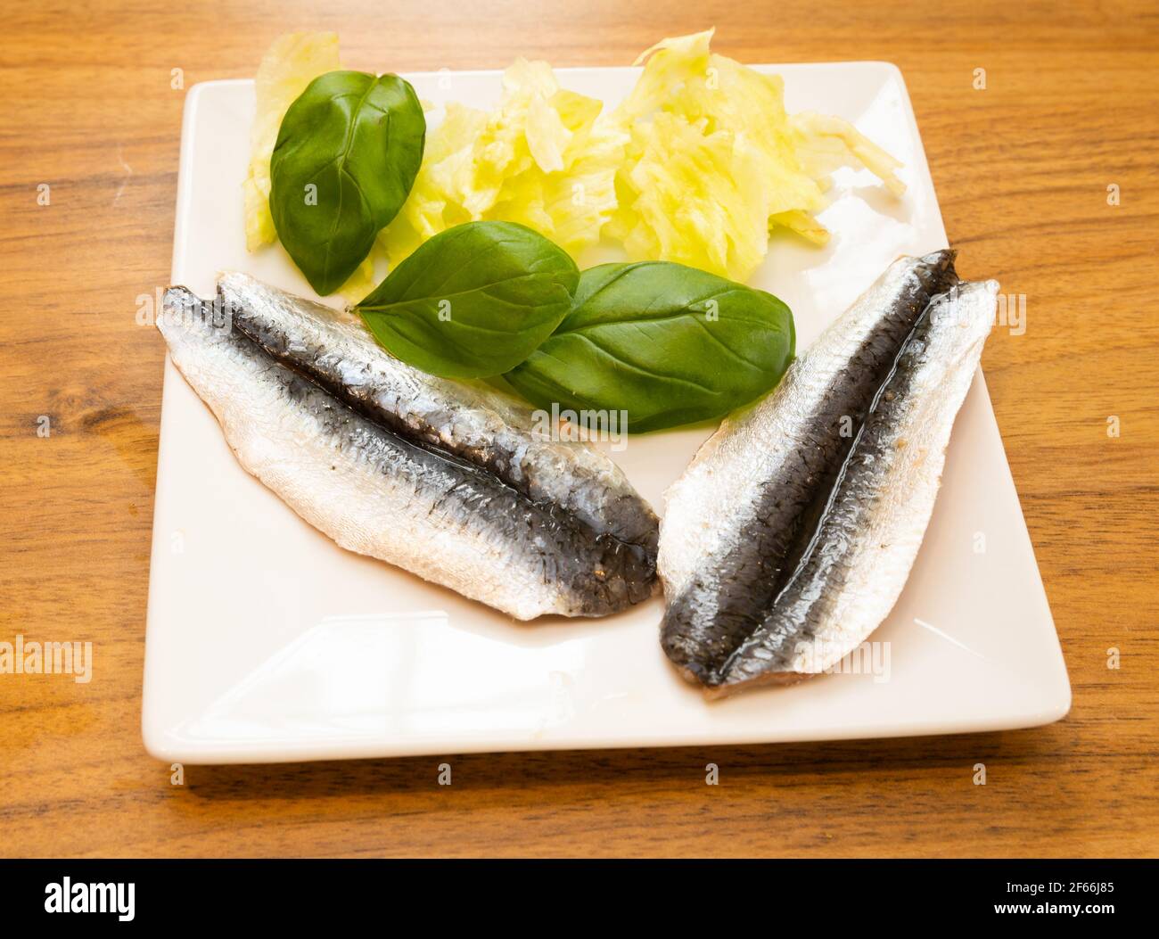 Raw North East Atlantic Butterfly Sardines on a plate before being cooked Stock Photo
