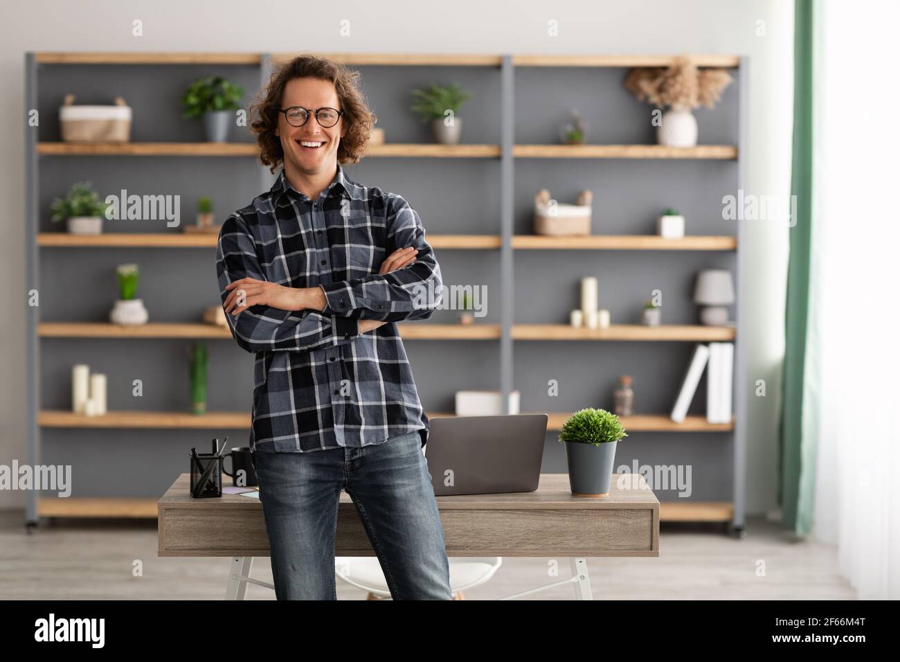 Happy Freelancer Hipster Guy Standing Posing In Modern Office Stock Photo