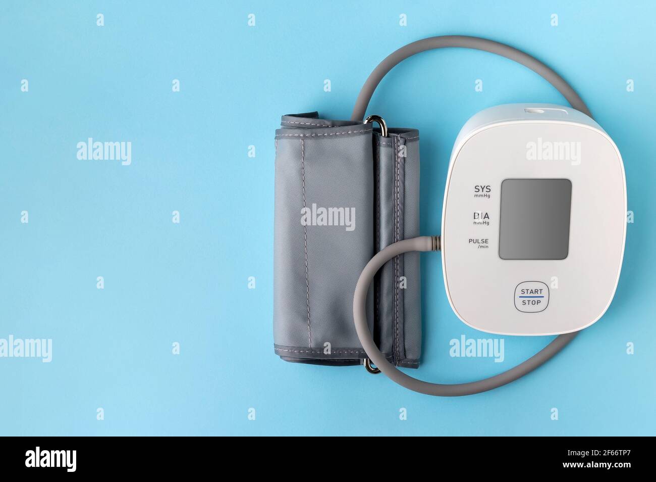 Automatic blood pressure monitor on blue background. Medical electronic ...