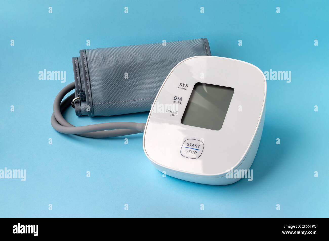 Automatic blood pressure monitor on blue background. Medical electronic ...