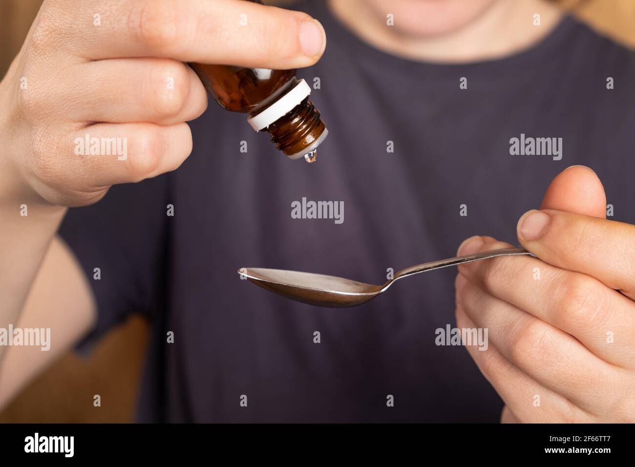 Liquid medicine pouring into spoon hires stock photography and images