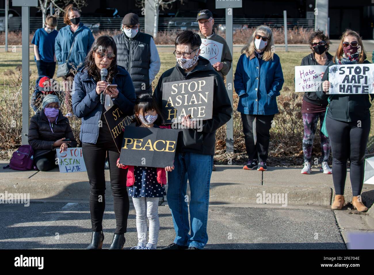 Maple Grove, Minnesota. March 25, 2021. Asian family speaking at a Stop Asian hate protest to remember the victims of the Atlanta Killings. Stock Photo
