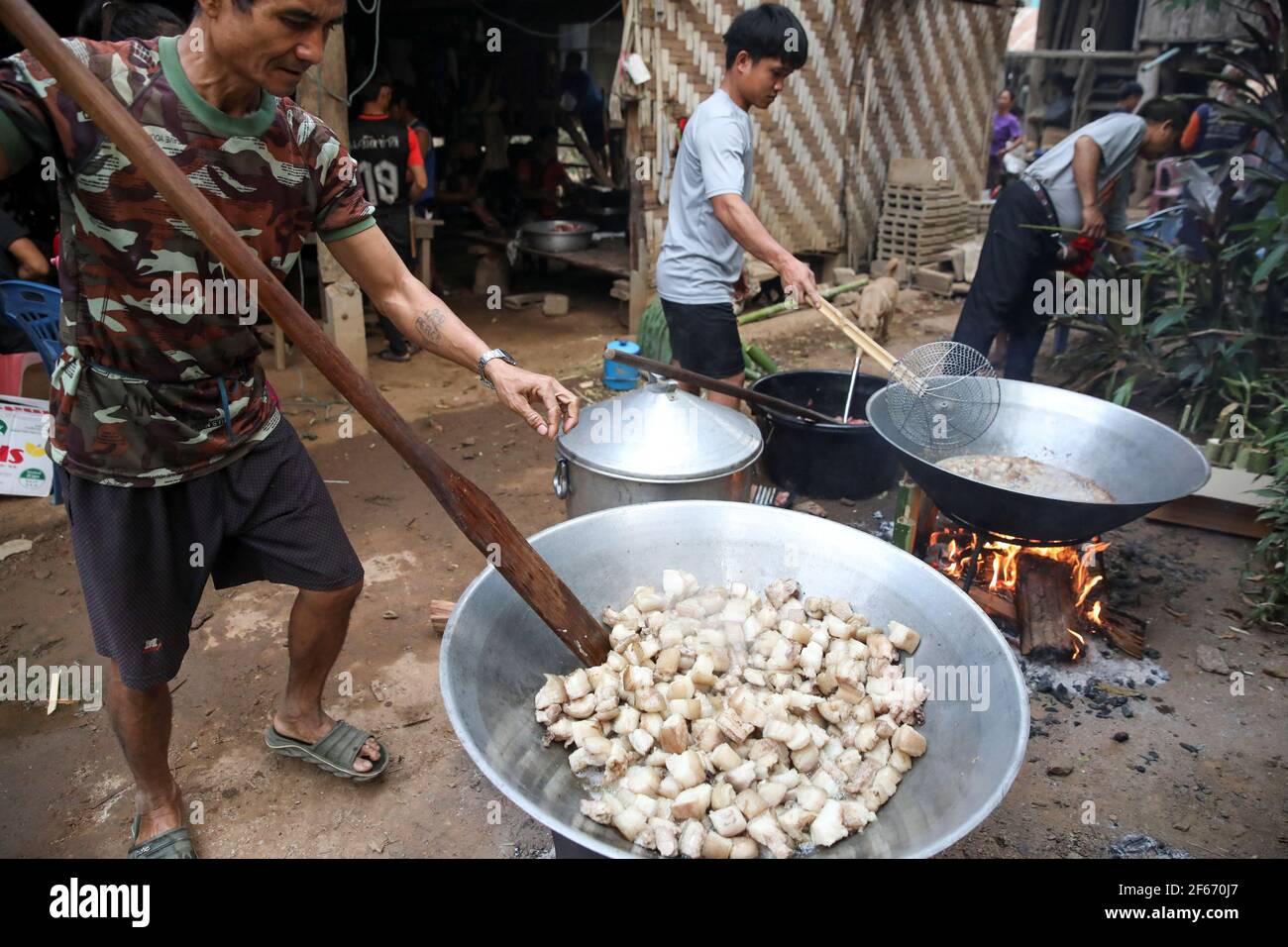 Izzie, 49, former Karenni Army (KNPP) cooks during a death anniversary in the Kayan village where people, who fled from Myanmar during the 1990s war between Myanmar's army and ethnic army groups, live in Mae Hong Son, Thailand March 25, 2021. Picture taken March 25, 2021. REUTERS/Soe Zeya Tun Stock Photo