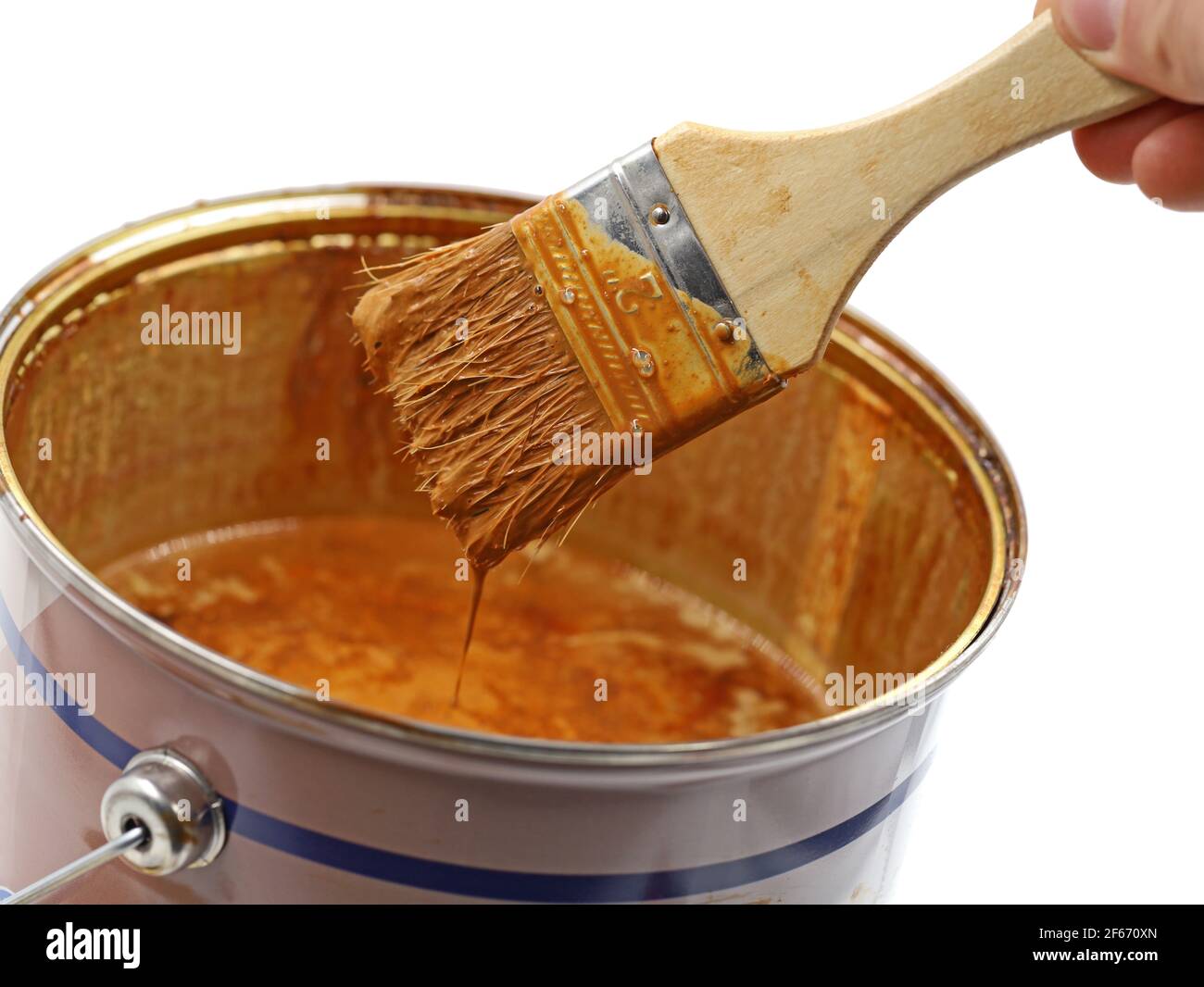 paint bucket with brown wooden glaze and used brush, close up Stock Photo