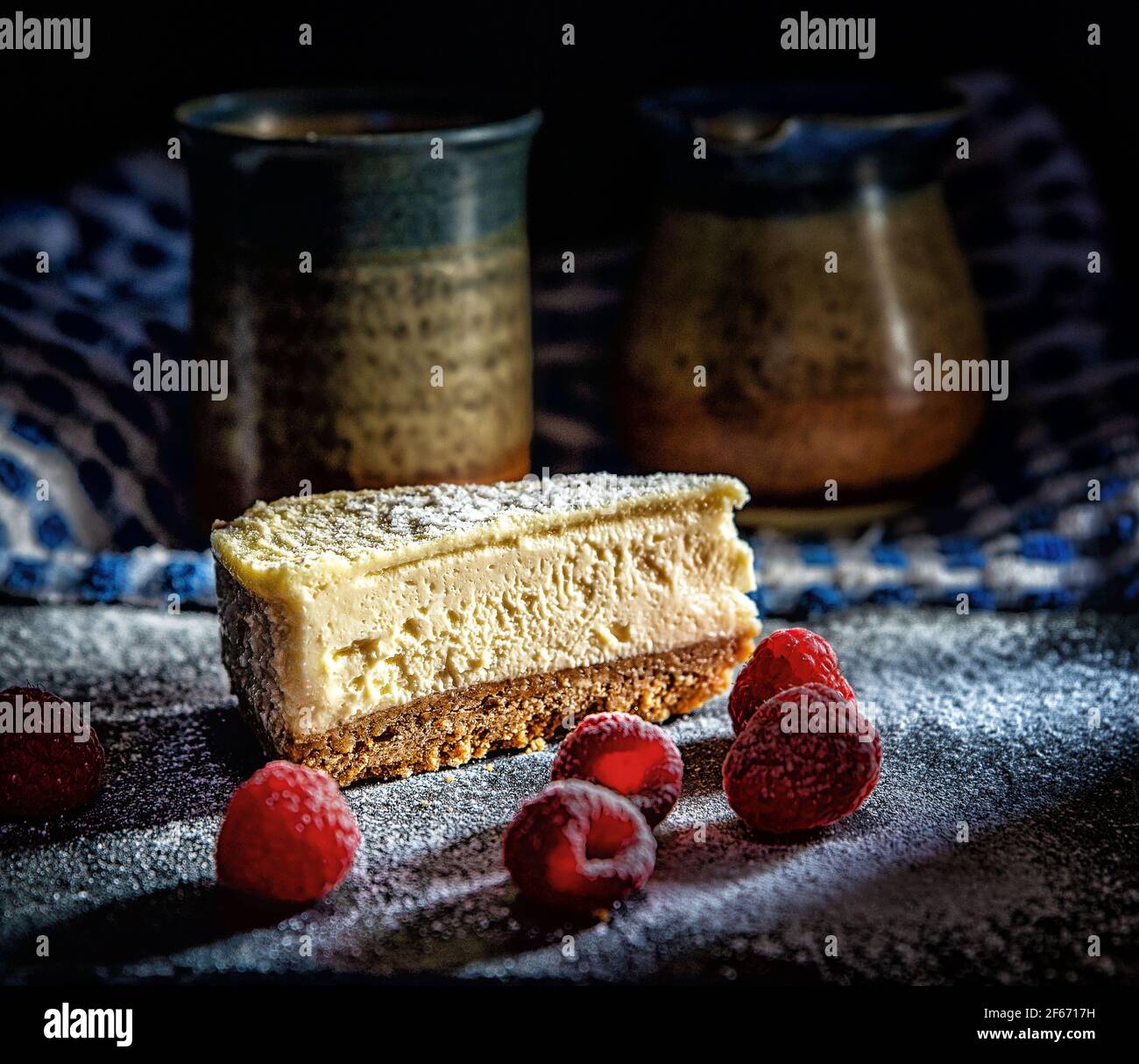 Cheesecake with berries in a low key setting food styling Stock Photo