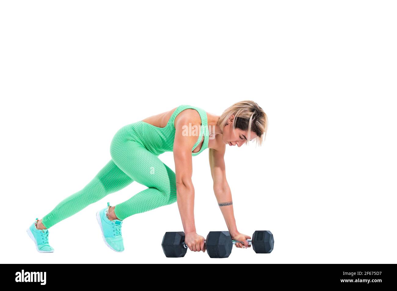 woman doing plank exercise on dumbbells isolated over white background Stock Photo