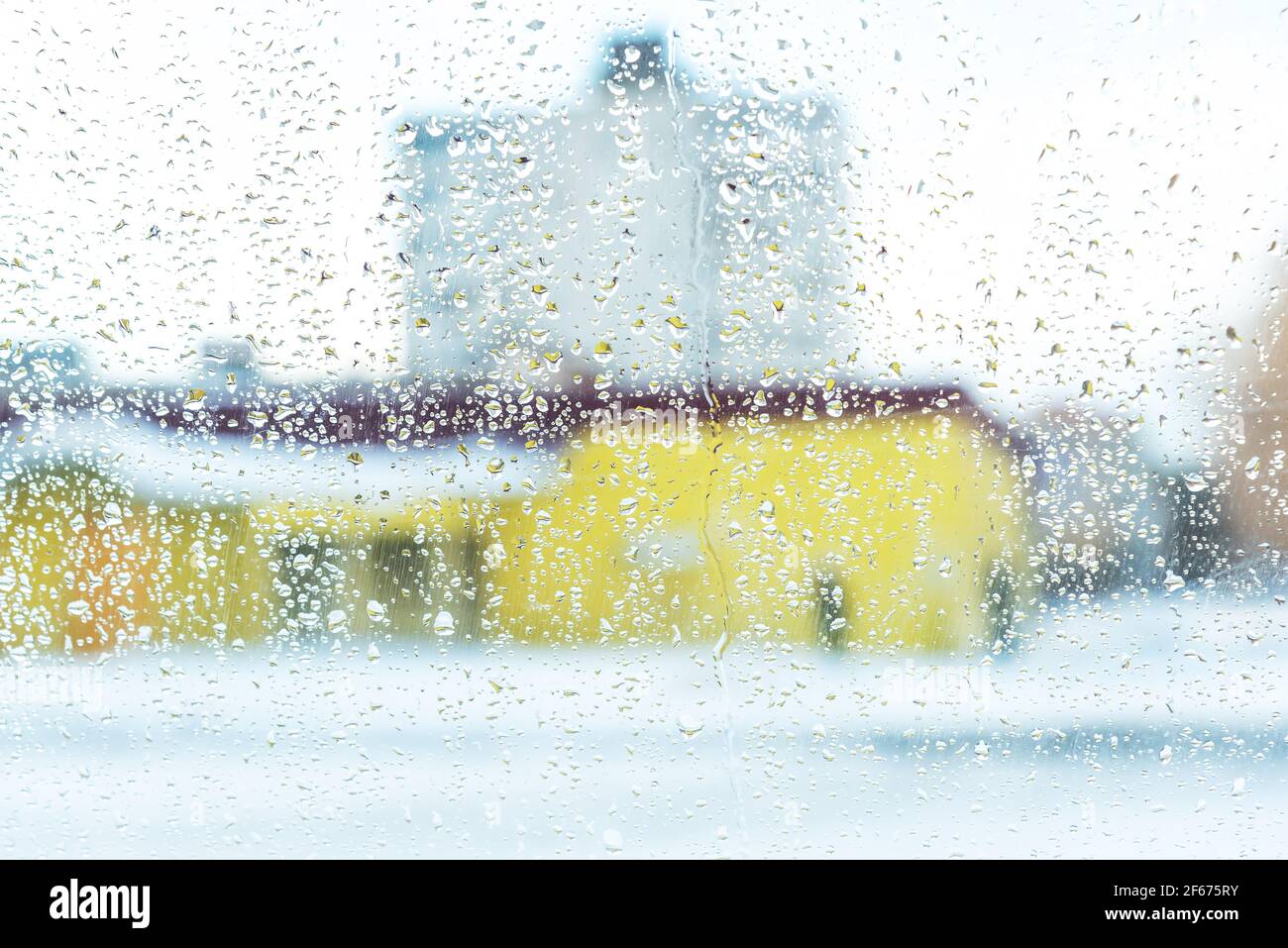 Urban view of rain drops falls on window Stock Photo