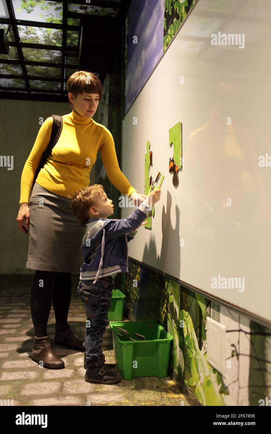 The family solving puzzles in a playroom Stock Photo