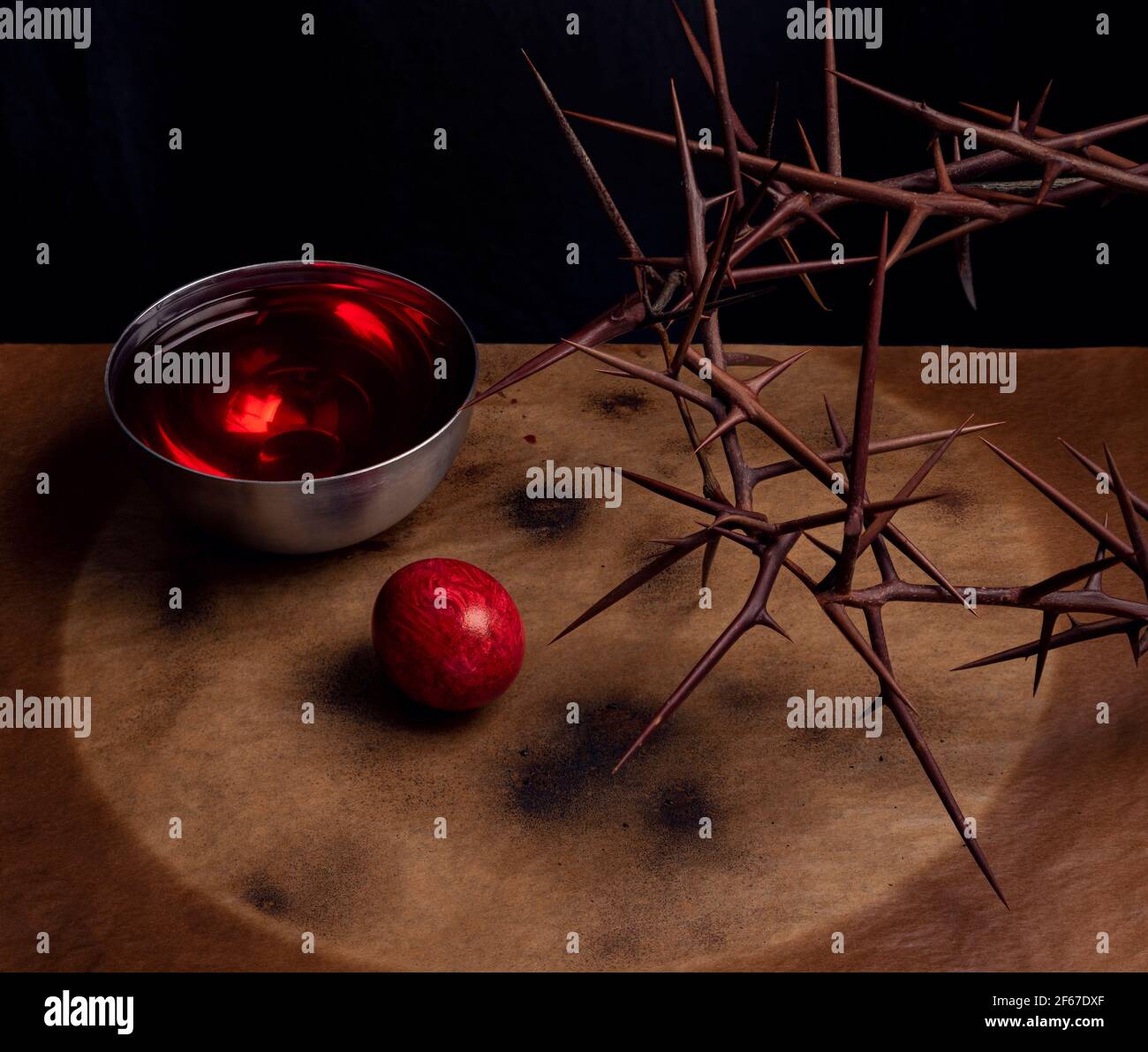 Rustic Easter background with crown of thorns, dyed egg and wine as