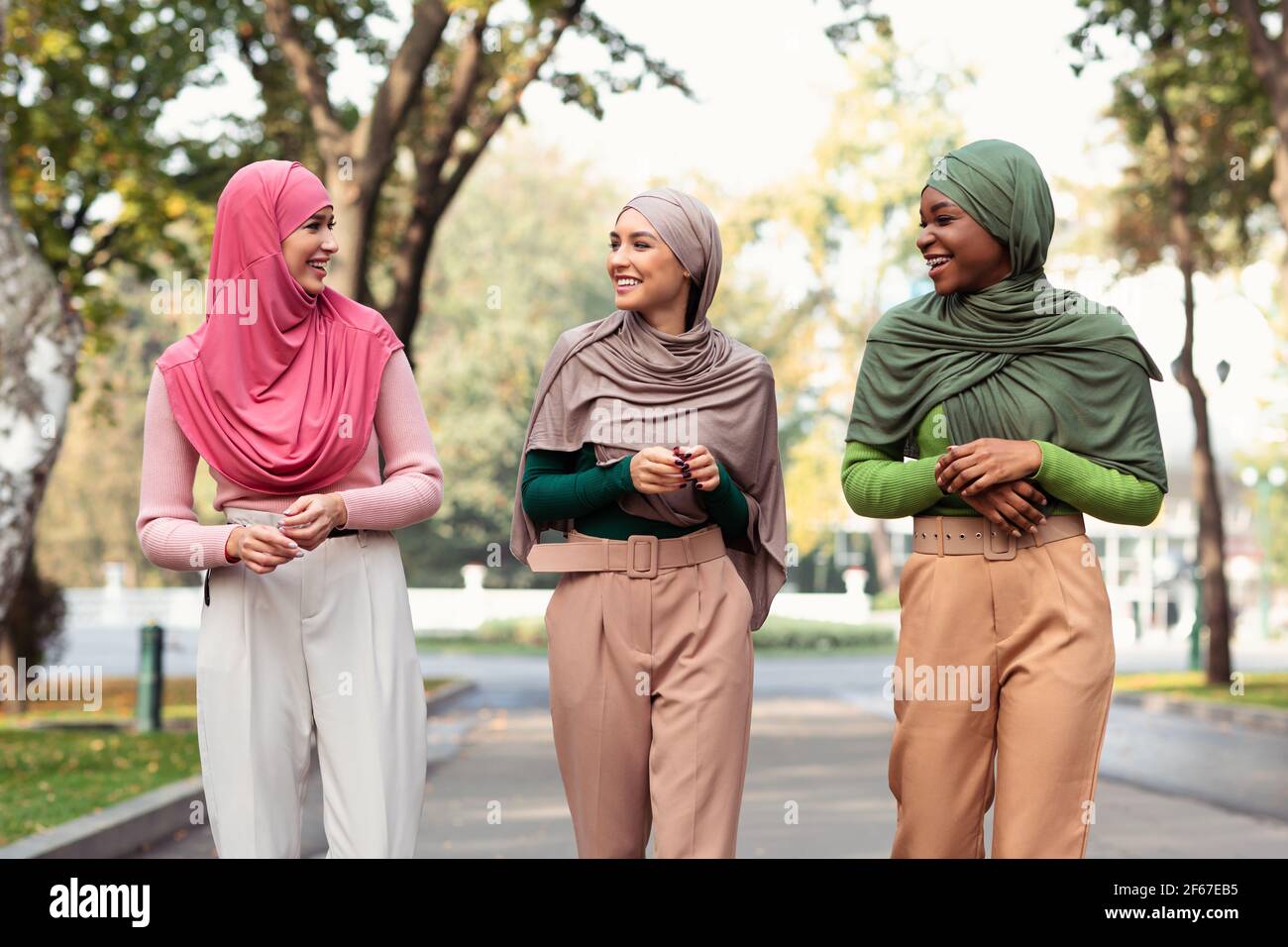 Three Young Muslim Women Talking Walking In City Park Outdoor Stock ...