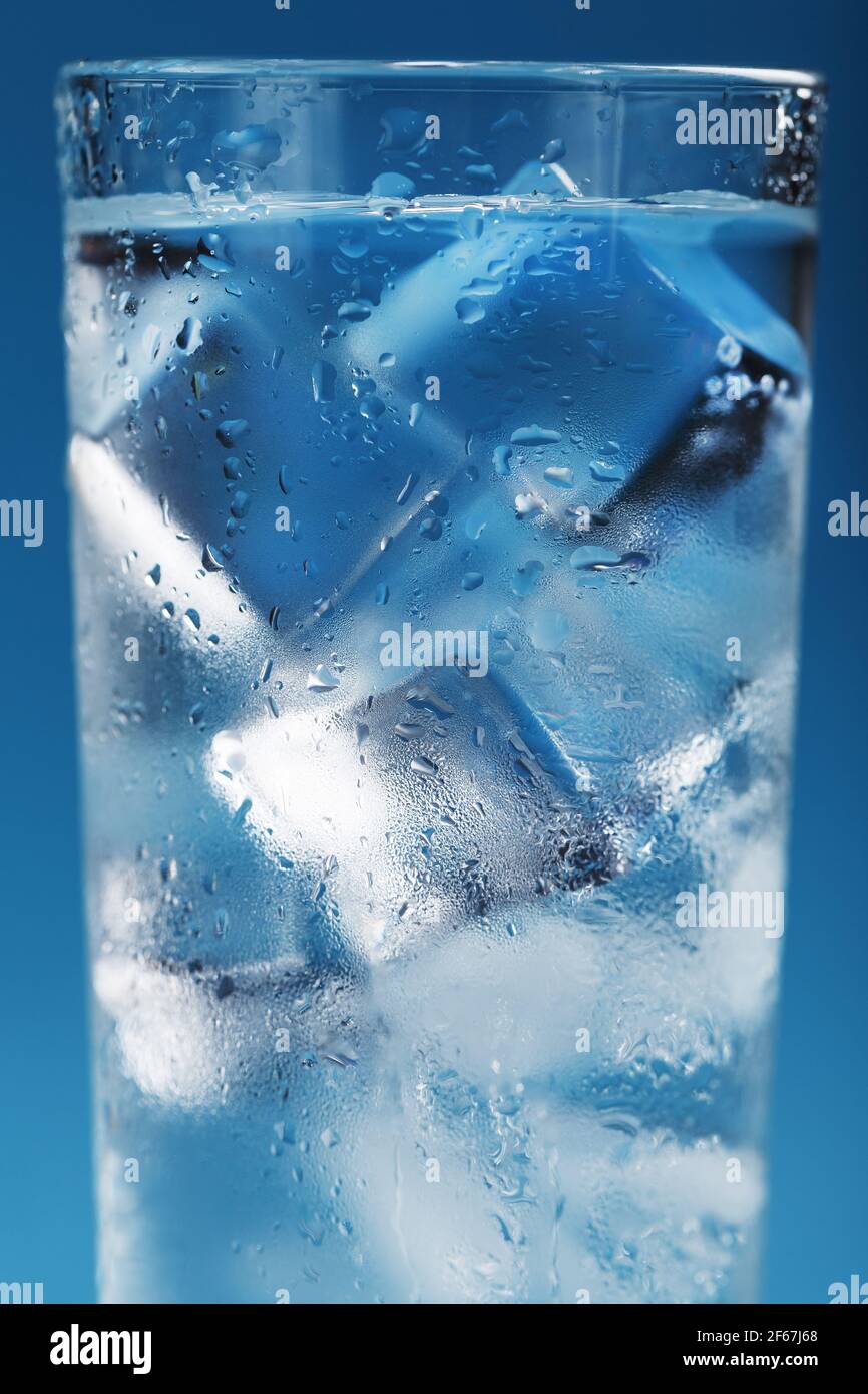 Ice cubes in a misted glass with drops of ice water closeup macro