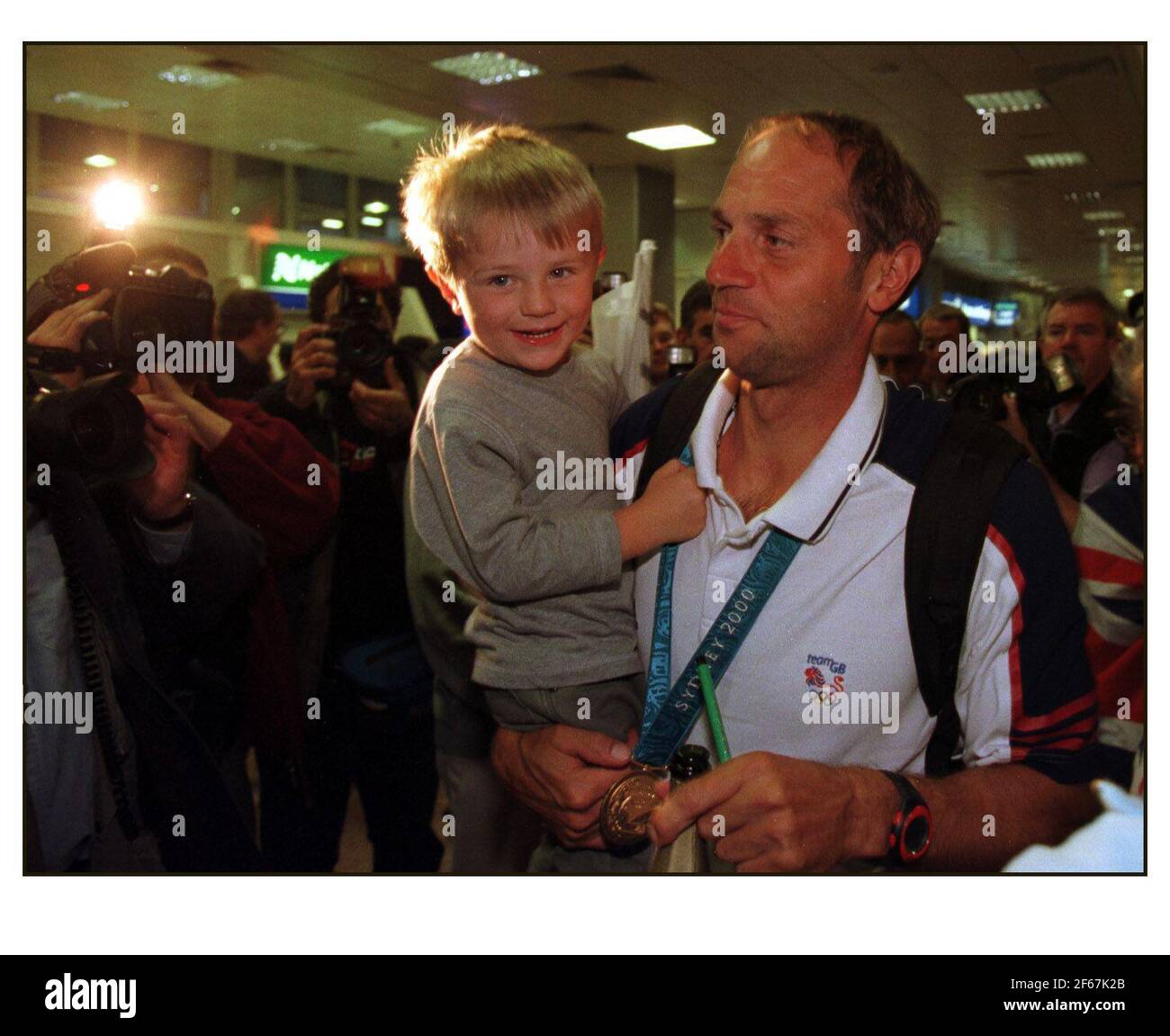 British Olympic Medalists arrive home at Heathrow airport....Steve Redgrave Coxless Four Rowing with son Zac Redgrave  Pic David Sandison Stock Photo