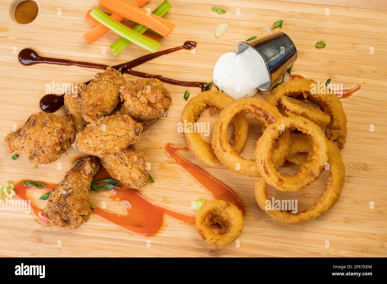 Chicken wings and onion rings with a pitcher of beer Stock Photo Alamy