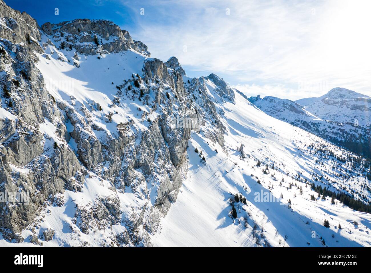 Aerial view of winter mountain landscape. Snow covered rugged rock massif, Vercors mountains, France. Stock Photo