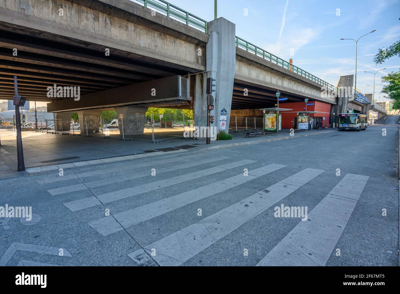 Low angle view of road crosswalk and bus station at elevated main road