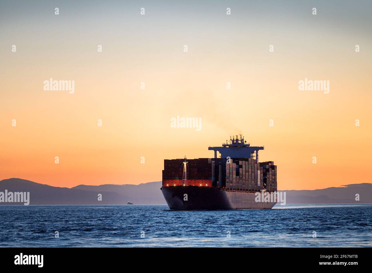 A container ships sails into the Port of Vancouver from English Bay. Stock Photo