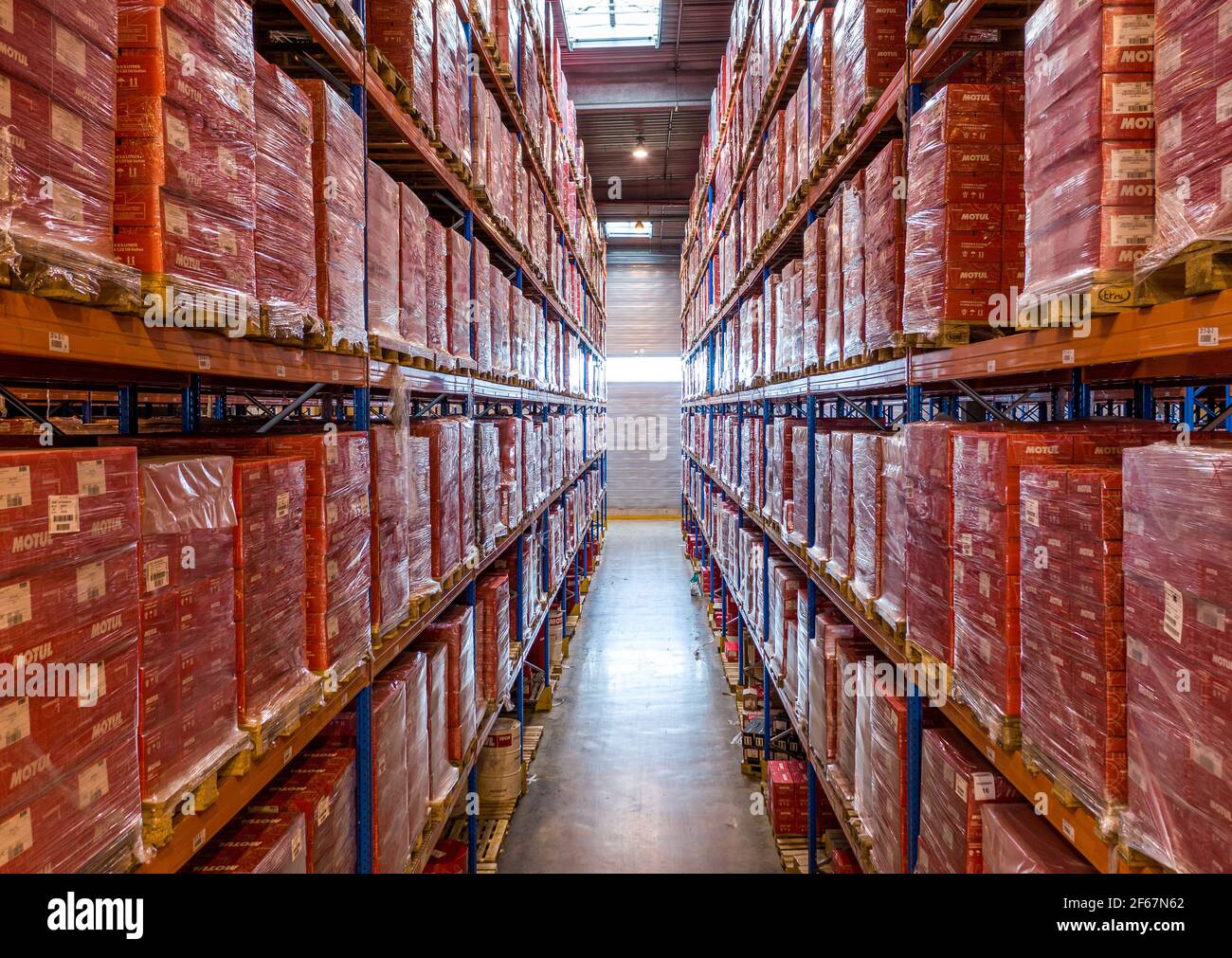 Rows of shelves with goods in distribution warehouse. Palettes with material stored in industrial racking system. Transport and logistics. Stock Photo