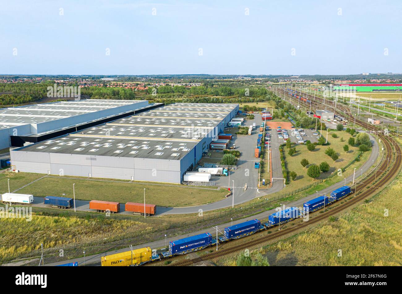 Aerial view of distribution centre with trucks and train. Logistic areal connected on railway
