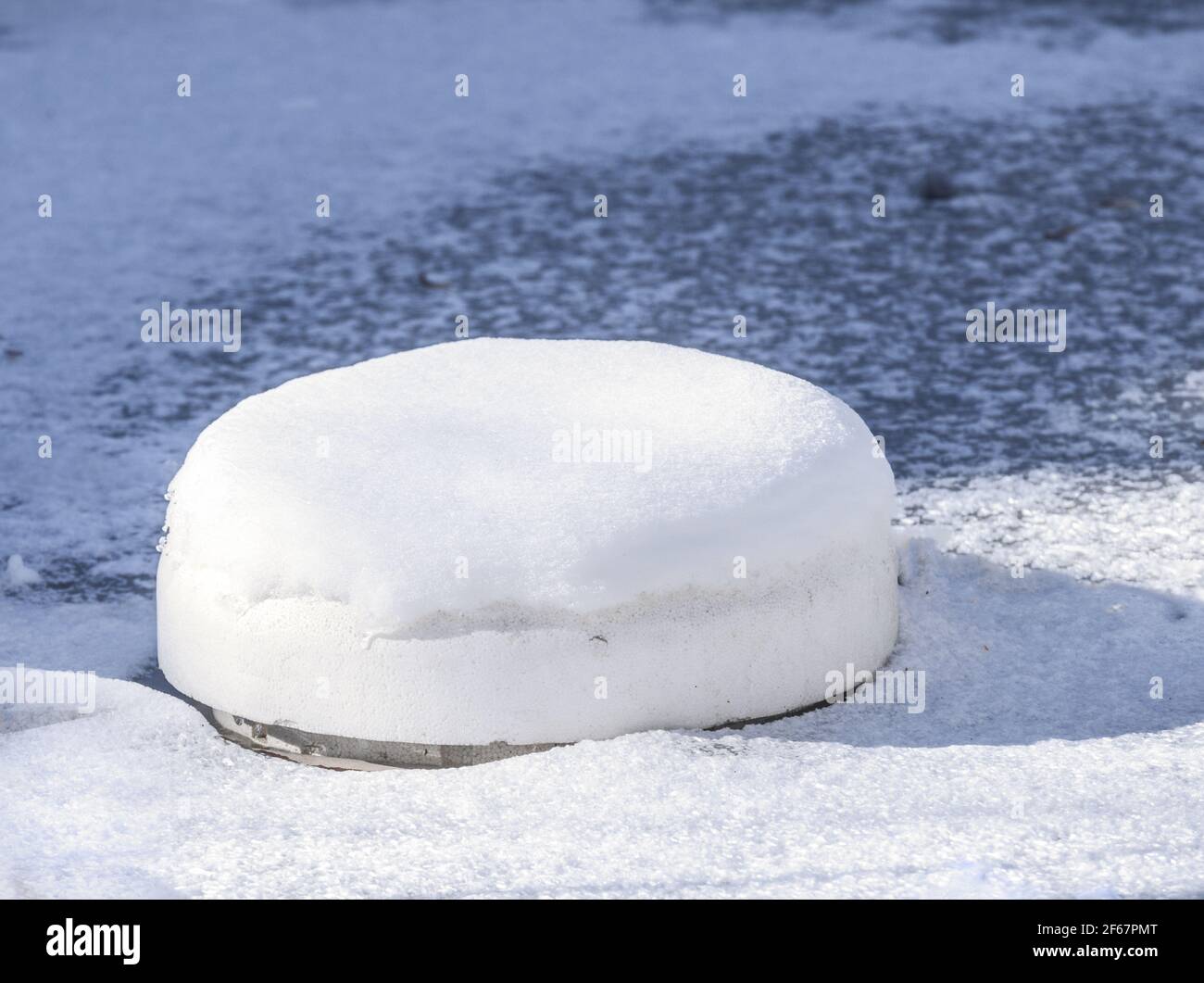 Floating ice preventer made of styrofoam in a frozen pond Stock Photo Alamy